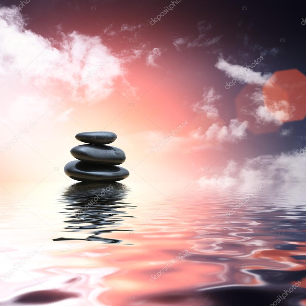 Zen stones reflecting in water background