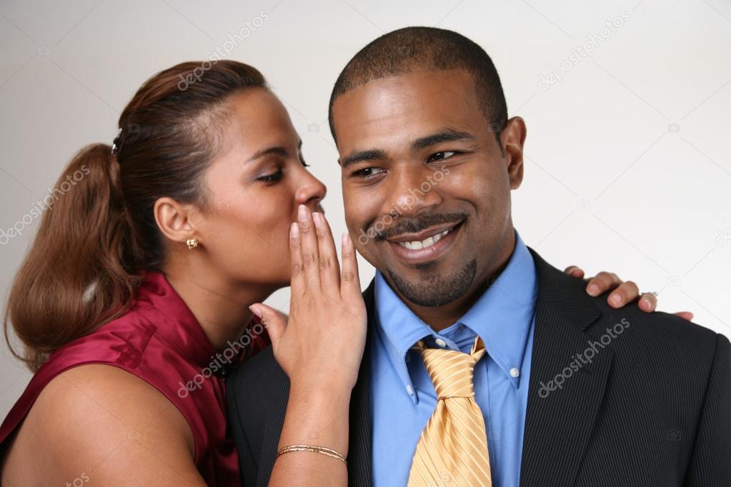 Woman wispering in husband's ear