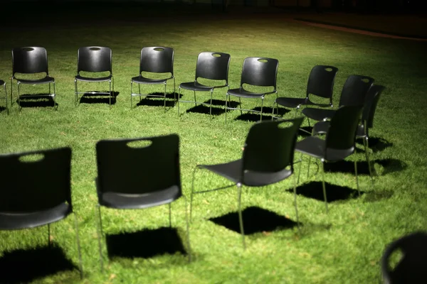 Black chairs on green grass — Stock Photo, Image