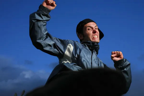 Angry hooligan over blue sky — Stock Photo, Image