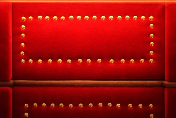 Red velvet with golden rivets retro background — Stock Photo, Image