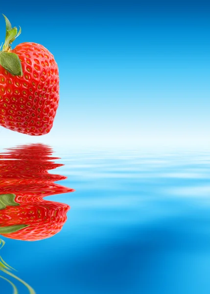 Red strawberry over blue water — Stock Photo, Image