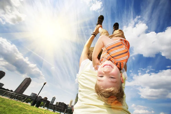 Boy hanging upside down on mother's back — Stock Photo, Image