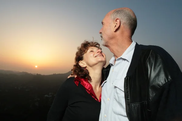 Happy mature couple outdoors at sunset — Stock Photo, Image