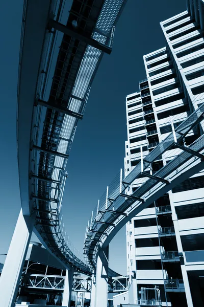 Futuristic monorail going around skyscrapers. — Stock Photo, Image