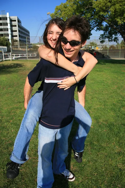 Couple playing piggyback ride — Stock Photo, Image