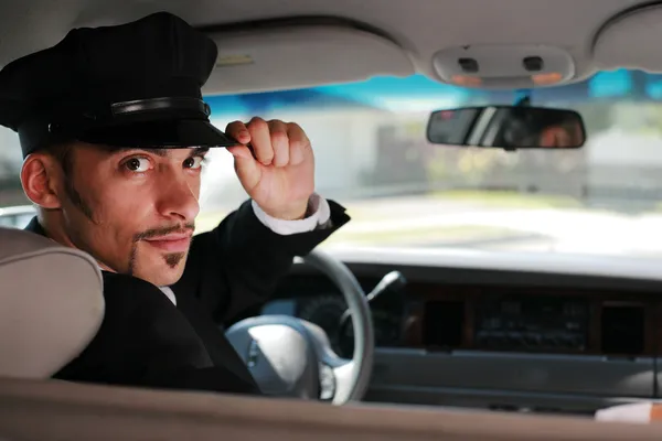 Chauffeur sitting in a car — Stock Photo, Image