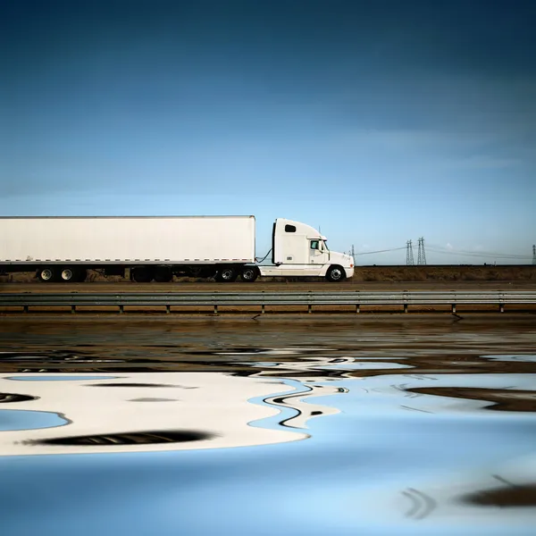White truck on the road under blue sky Stock Photo