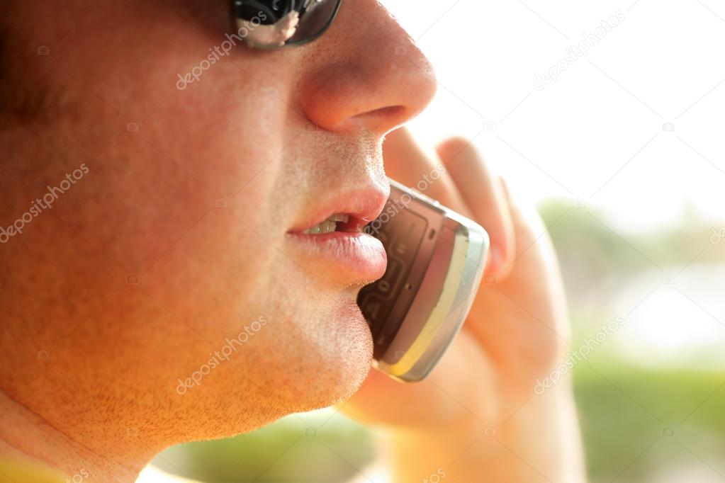 Close-up of man talking on cellular phone