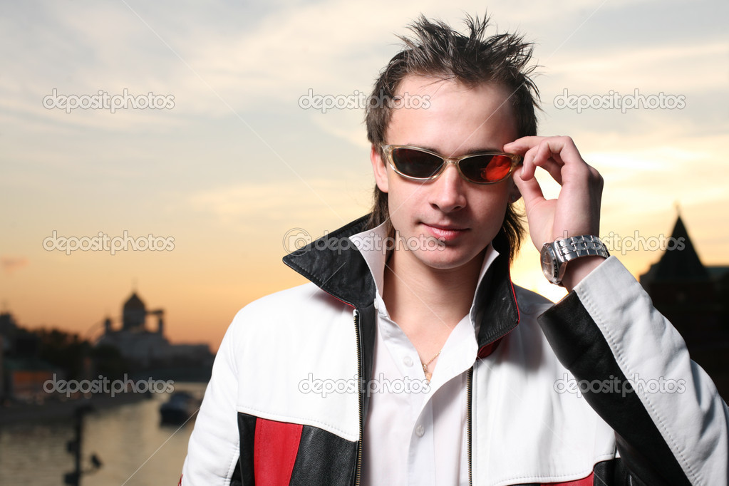 Handsome young man in orange sunglasses