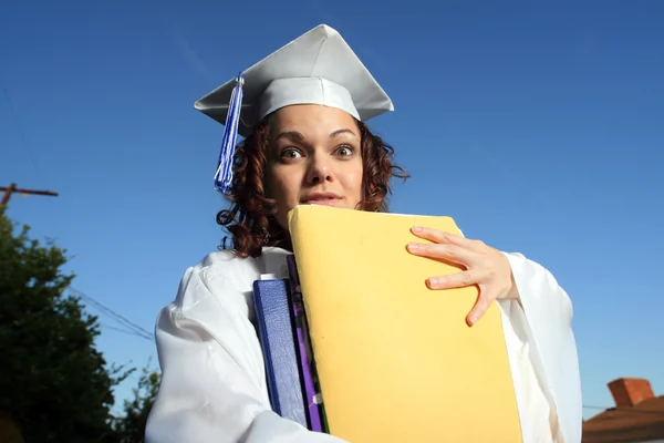 Student holding a big pile of textbooks — Stock Photo, Image