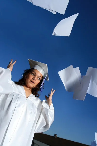 Young graduate throwing out school papers — Stock Photo, Image