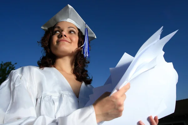 Young graduate with pile of papers — Stock Photo, Image