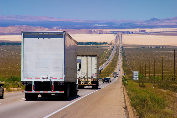 Delivery trucks on a highway.