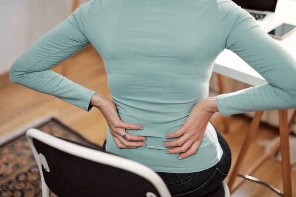 Woman with hip, back, spine spasm, cramp and pain, working from home troubles and issues.