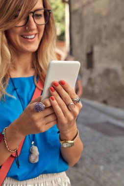 Sokakta smatrphone kullanan genç ve tatlı bir kadın..