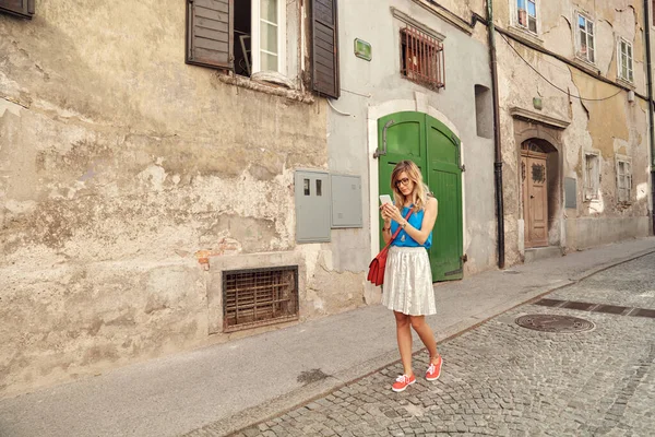 Sokakta smatrphone kullanan genç ve tatlı bir kadın..