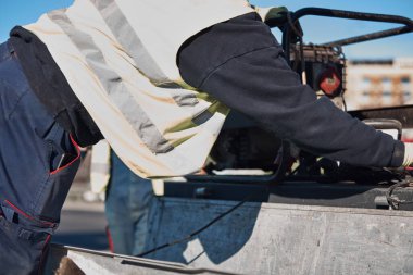 Construction maintenance workers working at public site street road.