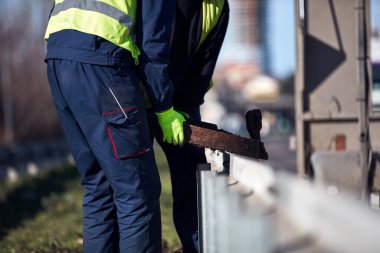 Construction maintenance workers working at public site street road.