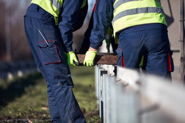 Construction maintenance workers working at public site street road.