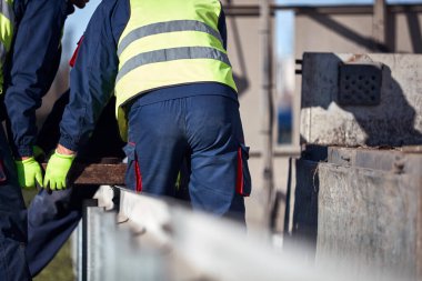 Construction maintenance workers working at public site street road.