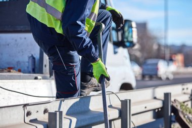 Construction maintenance workers working at public site street road.