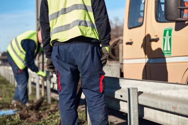 Construction maintenance workers working at public site street road.