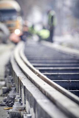 Railway track with nuts and bolts on a construction site.