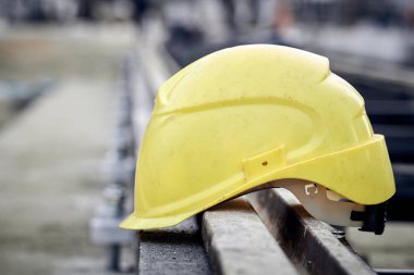Construction protective helmet on a steel railway track.