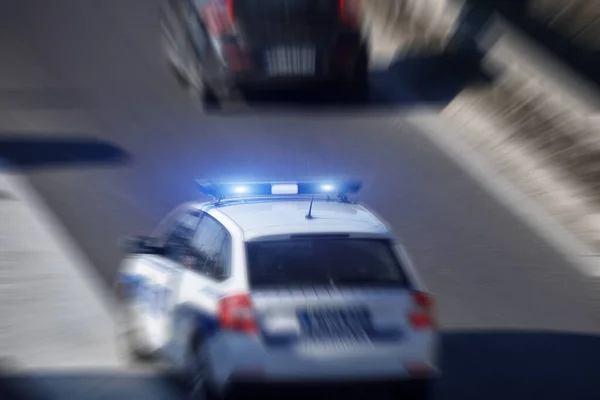 Police Car Blue Lights Moving Fast Traffic Urban Environment — стоковое фото
