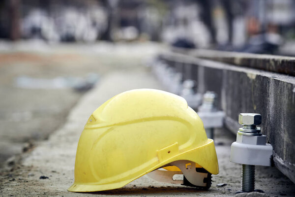 Construction protective helmet on a steel railway track.