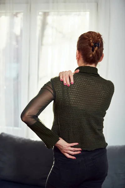 Woman with shoulder and back pain.