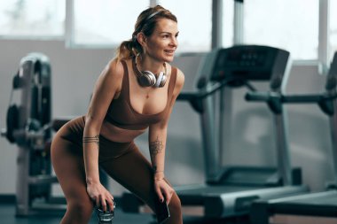 Spor salonunda çalışan güzel bir kadın. Güzel vücutlu, yetişkin, güzel, sportif bir bayan..