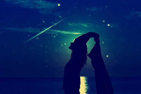 星空の下で楽しむ女性海の上の月明かりの夜 — ストック写真