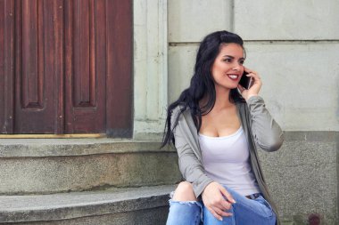 Sokakta akıllı telefon kullanan hoş bir bayan..