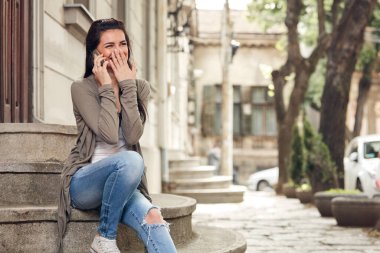 Sokakta akıllı telefon kullanan hoş bir bayan..