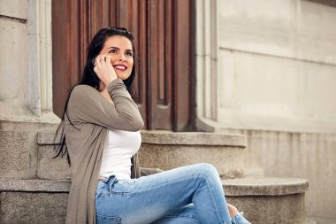 Sokakta akıllı telefon kullanan hoş bir bayan..