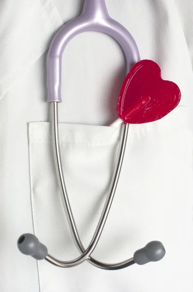 Doctor with a heart shaped lollipop. — Stock Photo, Image