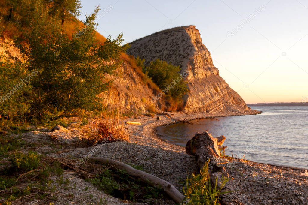 Dawn on the Volga. Beautiful cliffs by the river in the morning rays of the rising sun at golden hour