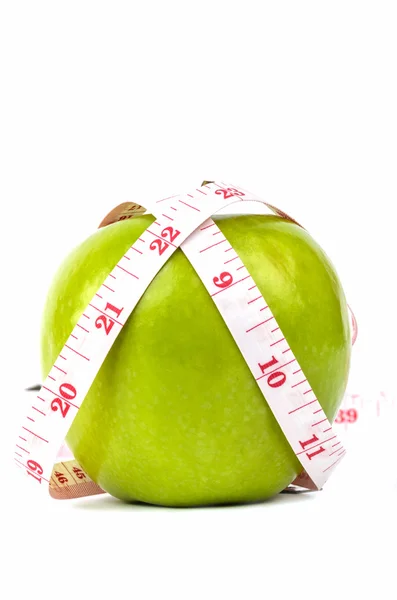 Zielone jabłko i białą taśmę — Zdjęcie stockowe