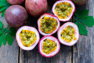 Passion fruit ( Maracuya ) with Passion fruit cut in half slice on wooden table background .