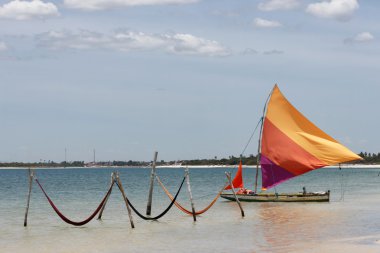 Beautiful sail boat and hammocks at the Paradise Lake (Jericoacoara, Brazil) clipart