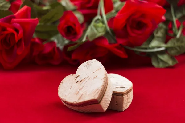 Two hearts with roses in the background — Stock Photo, Image