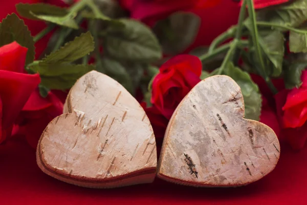 Two hearts with roses in the background — Stock Photo, Image