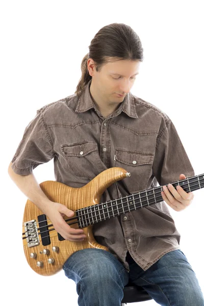 Bass guitarist concentrated on his bass guitar — Stock Photo, Image