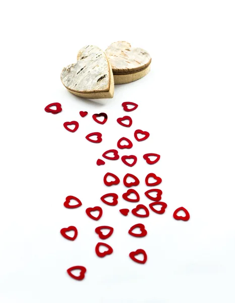 Red hearts and wooden hearts — Stock Photo, Image