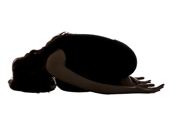 Woman doing childs pose in yoga, silhouette — Stock Photo, Image