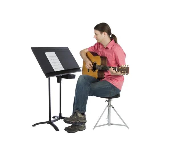 Musician looking at music notation and playing — Stock Photo, Image