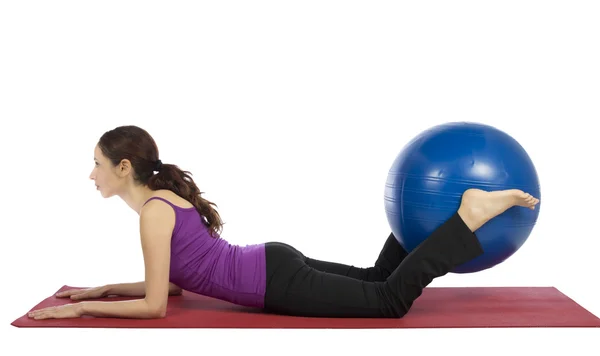 Young fitness woman doing pilates exercises with a pilates ball Stock Photo
