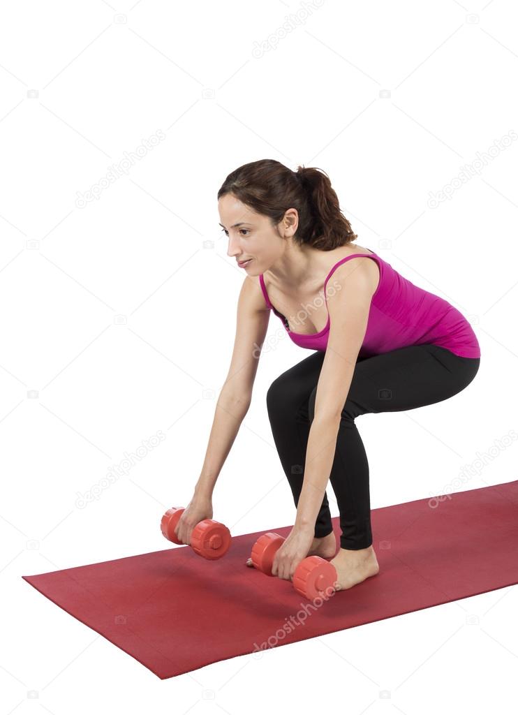 Woman doing lunge with dumbbells in fitness